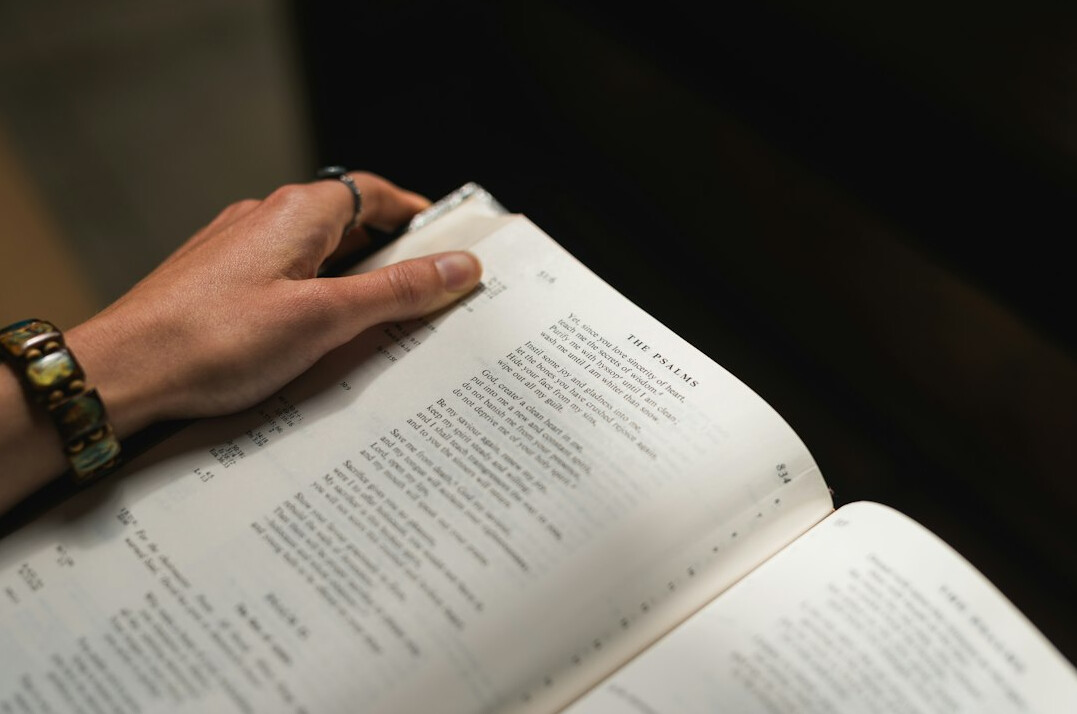 Close-up of hands reviewing printed documents and highlighting text